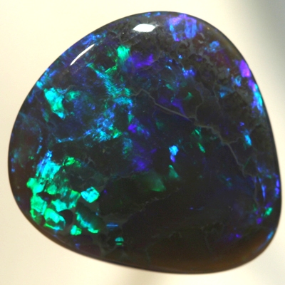 SOLID BLACK CRYSTAL OPAL Bright greens play over a background hue of purple blue SEE VIDEO